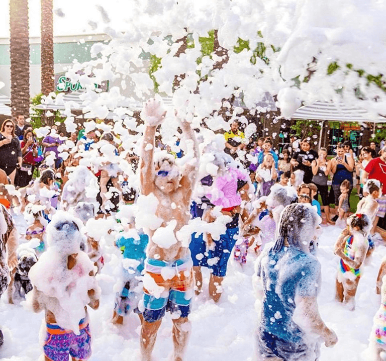 Large group of kids and adults in a foam party